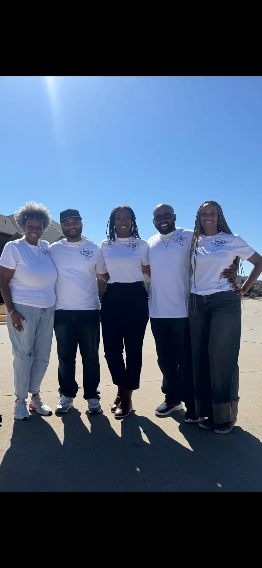 Nicole King standing with four campaign volunteers